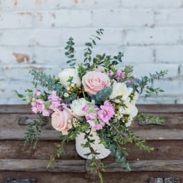 Pink and white floral arrangement in a white vase