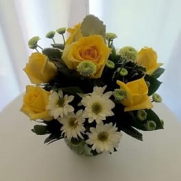 Yellow roses and white daisies in a compact bouquet