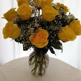 Yellow roses arranged in a clear glass vase