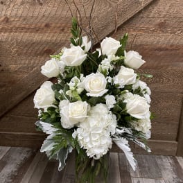 White roses and hydrangeas in a glass vase