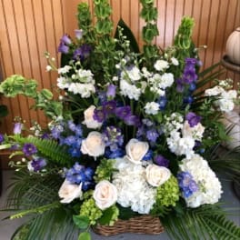 Large basket arrangement of white, purple, and blue flowers