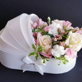 Pink and white bouquet in a white heart-shaped box