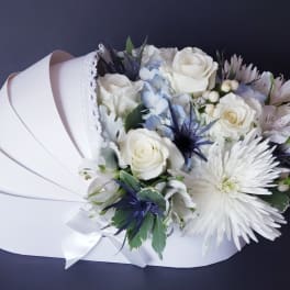White rose bouquet with pale blue accents in a white box