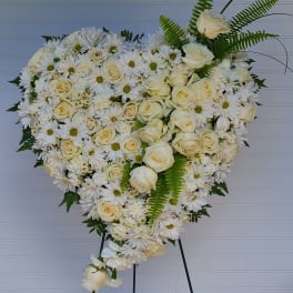 Heart-shaped white floral spray on an easel