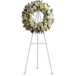 White floral wreath on a standing easel