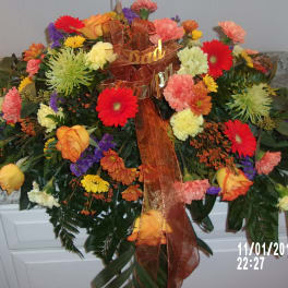 Large mixed floral arrangement with a brown ribbon and "Dad" sign