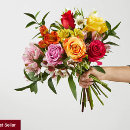 Handheld bouquet of multicolored roses and alstroemeria