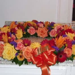Colorful floral wreath with roses, carnations, and daisies on a countertop