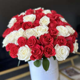 Bouquet of red and white roses in a white hatbox