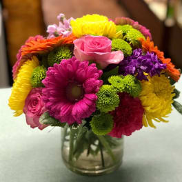 Colorful mixed bouquet in a clear glass vase