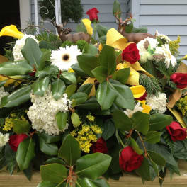Large floral arrangement with red roses, white blooms, and yellow accents
