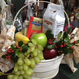 Gift basket with fruit, chocolates, and decorative ribbon