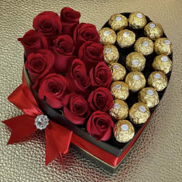 Heart-shaped box with red roses on one side and gold-wrapped chocolates on the other