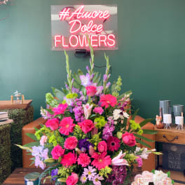 Large mixed bouquet with pink, purple, and white flowers in a basket