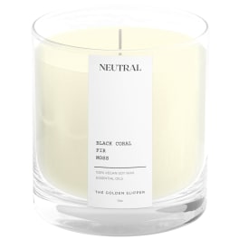 Cream candle in a clear glass jar with a label