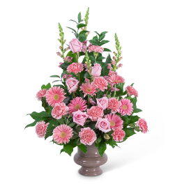 Pink roses, carnations, and gerbera daisies in a vase