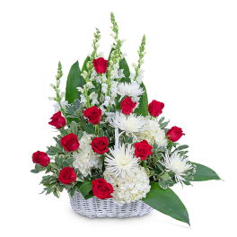 Red roses and white flowers in a white basket