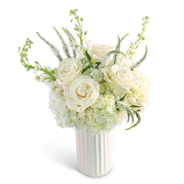 White roses and hydrangeas in a white vase