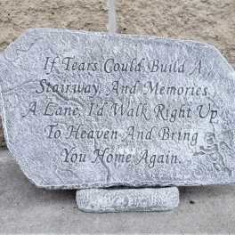 Engraved memorial stone with a poem on a stand