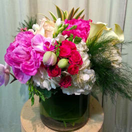 Pink and white mixed bouquet in a dark glass vase