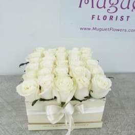White rose arrangement in a square box with a ribbon