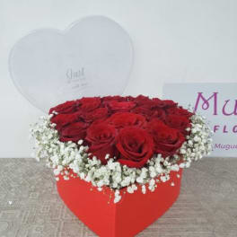 Heart-shaped box of red roses with white baby's breath