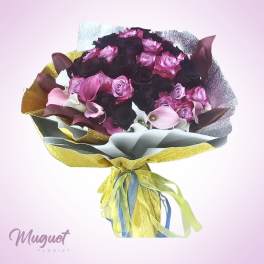 Bouquet of pink and dark roses with calla lilies wrapped in metallic paper