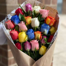 Bouquet of multicolored roses wrapped in brown paper