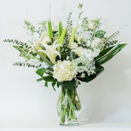 White floral arrangement in a clear glass vase