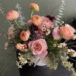 Pink and peach mixed bouquet in a white vase