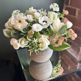 Soft pastel bouquet in a round ceramic vase
