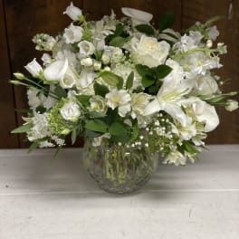 White floral arrangement in a clear glass vase