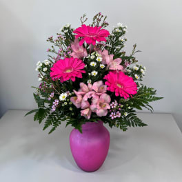 Pink and white mixed bouquet in a magenta vase