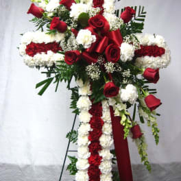 Cross-shaped floral spray with red roses and white carnations