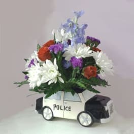 Flower arrangement in a police car-shaped container