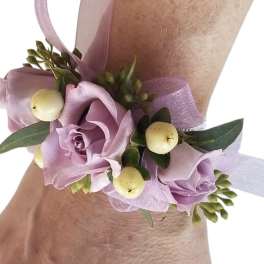 Lavender rose wrist corsage with ribbon and pale berries