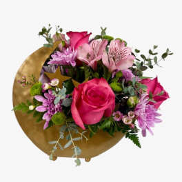 Pink and purple bouquet with roses and daisies in a gold wrap