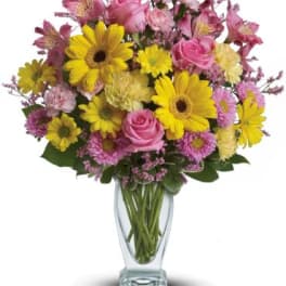 Mixed pink and yellow bouquet in a clear glass vase