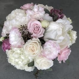 Round bouquet of pale pink and white roses with white blooms