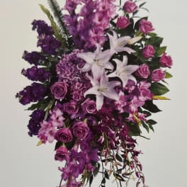 Purple floral standing spray with lilies and roses