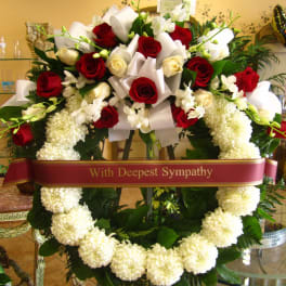 Sympathy wreath with red and white roses and white flowers