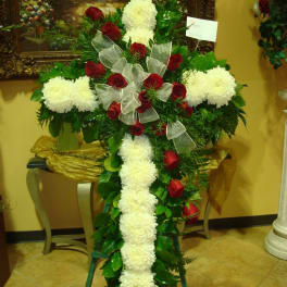 Cross-shaped floral tribute with red roses and white chrysanthemums