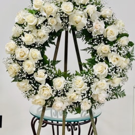White rose funeral wreath on a standing easel