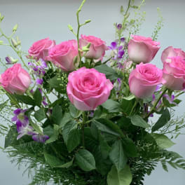 Pink roses with purple accents in a mixed bouquet