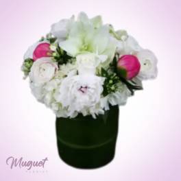 White and pink flower arrangement in a dark vase