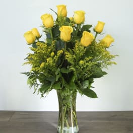 Yellow roses arranged in a clear glass vase
