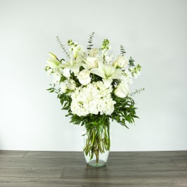 White floral arrangement in a clear glass vase