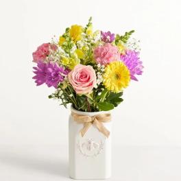Mixed bouquet in a white vase with a burlap bow