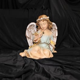 Angel figurine with white wings and a floral headband