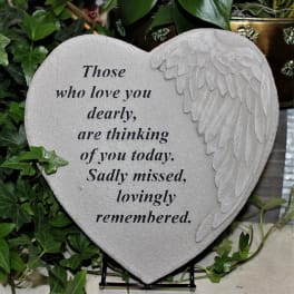 Heart-shaped memorial plaque with angel wing relief and sympathy text